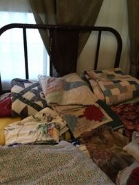 Quilts, linens and old metal bed with the old metal springs!