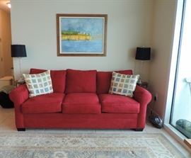 CINDY CRAWFORD HOME RED SOFA, PAIR OF BLACK METAL SIDE TABLES, PAIR OF LAMPS & LARGE AREA RUG (PAINTING NOT FOR SALE)