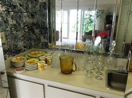 Method ‘Poppy Fields’ dinnerware with assorted glassware and some crystal glasses.