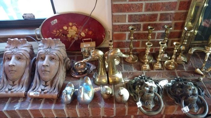 matching Indian motif heads used to keep up shelf, brass lions heads door knocker, brass candle holders, brass ducks, brass clock and fireplace screen holders