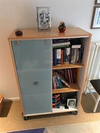 modern book case (on wheels) with frosted glass accents. 