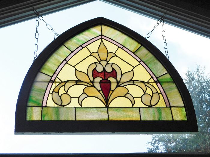 This stained glass is pictured in the window of the condo. It is a large, vintage piece. 