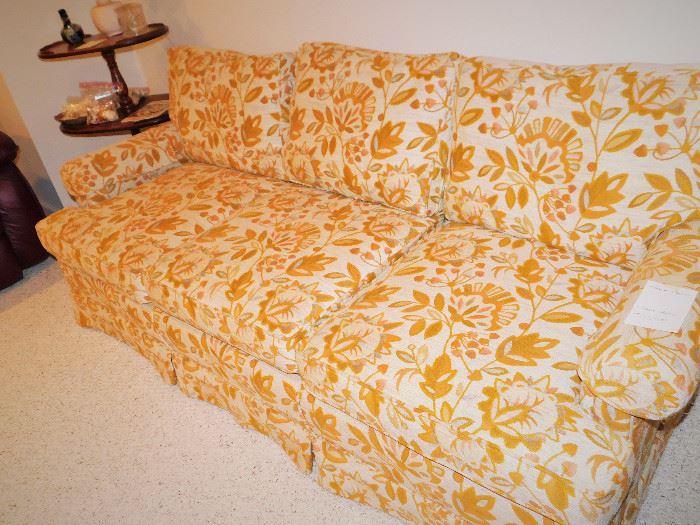 This retro sofa looks better in person. Besides the gold and cream there are accents of grey and lavender.