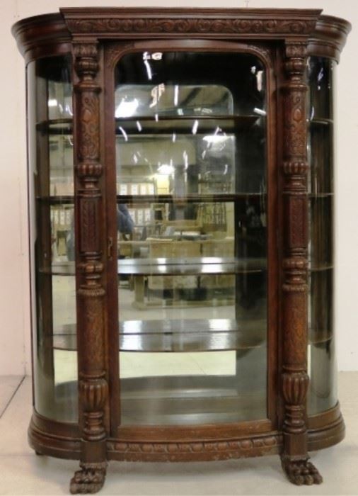 Heavily carved oak triple bow glass china cabinet