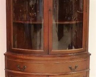 Mahogany bowed glass corner cabinet