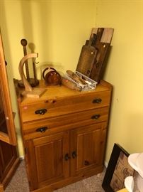 Wood cutting boards, paper towel rack, banana hanger, wooden spoons, napkin holder, rolling pin, and wood cabinet