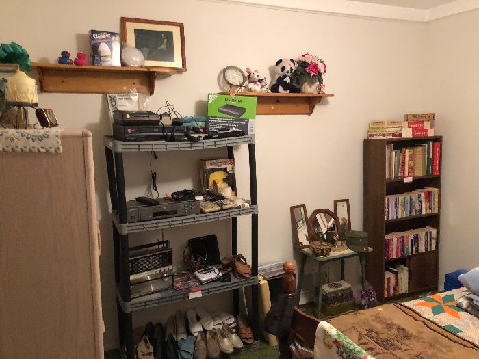 VHS player, DVD player, Antique radio, other electronics, woman’s shoes, mirrors, cook books, reading books, twin bed set