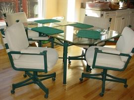 Beautiful glass and iron table with matching upholstered chairs on coasters