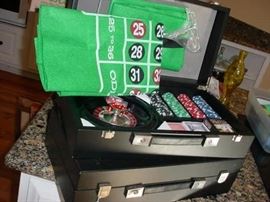 Several sets of casino chips, cards, and more