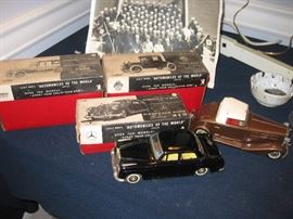 There is a nice assortment of these vintage Japanese tin cars from the "Automobiles of the World" series. All friction power, excellent new in box, ...plus you can see the military photo behind