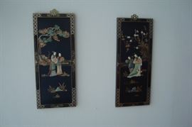 Oriental wall hangings with raised mineral figures.