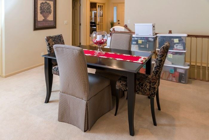 Black 60 inch table with six upholstered chairs. With leaf extends to 80 inches.