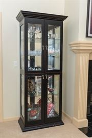 Lighted curio cabinet with glass shelves.