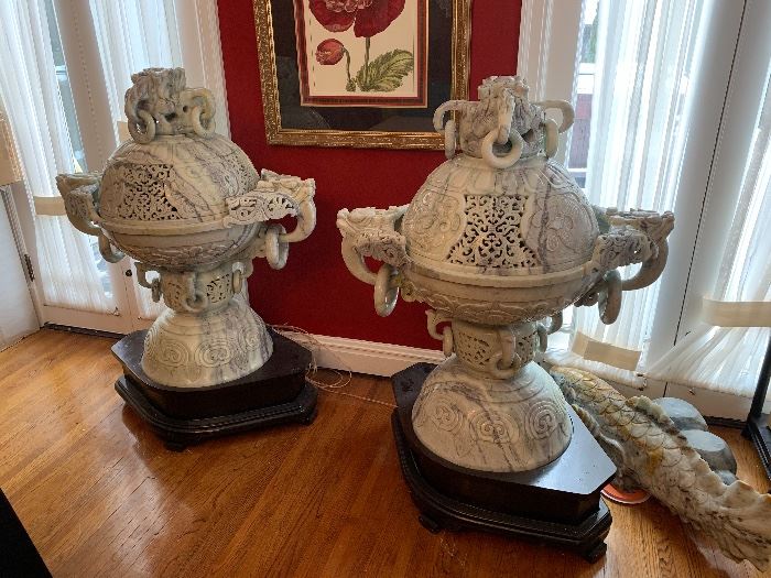 Huge carved censors. The owner has installed light fixtures inside to create an even greater dramatic effect from these monumental pieces.