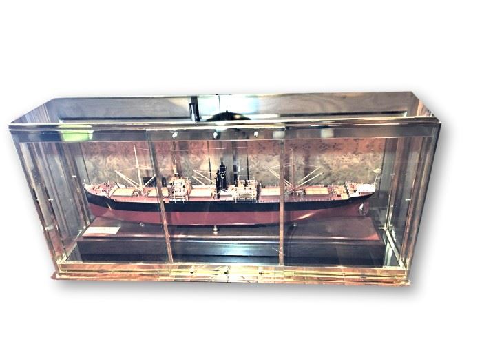 Cabinet measures 62 inches long by 14 inches deep by 29 inches high. Ship measures approximately 50 inches long.