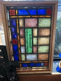 Stained glass window with dedication inscription