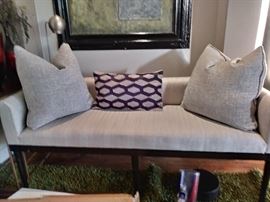 Parlor Bench covered in a light  colored fabric 