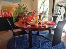 Wood Dinning Table Five Feet in Diameter with Four Leather Chairs