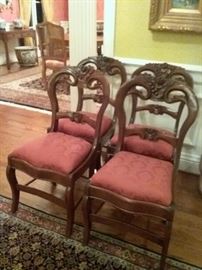 4 Carved Victorian Chairs with floral and berry motif on the crest rail.