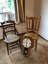 A pair of chairs and a pendulum clock