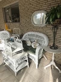 Sunporch filled with white wicker furniture