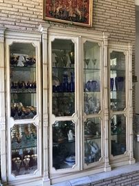 Oversized (6’11” by 6’8”) display cabinet filled with crystal, porcelains, and Lladro