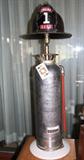 Vintage fire extinguisher lamp topped off with vintage fireman's hat