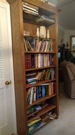 Tall bookshelf with some glass shelves.