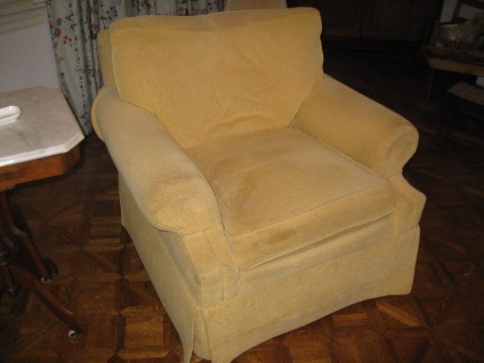 One of a pair of swivel upholstered chairs by the Charles Stewart Co.