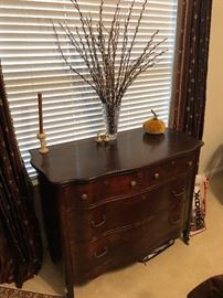 Gorgeous antique mahogany serpentine dresser on original casters 
