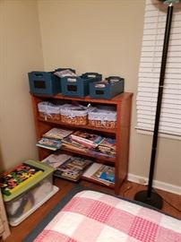 Pottery Barn Kids bookshelf with gingham lined straw baskets and graduated blue wood bins