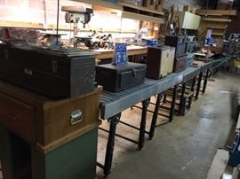 Another view of the conveyor tables and some old tool boxes and projectors. 