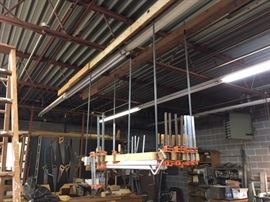 Overhead shelf suspended from the girders.