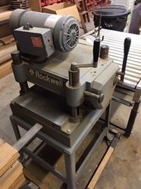 This is the backside of the planer sitting on top of it's metal base with wheels.