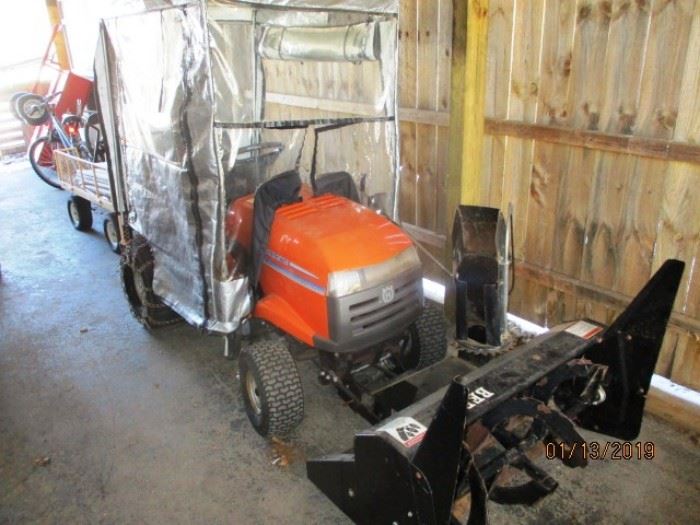 Husqvarna mower with snow blower attachment and cover has mower deck
