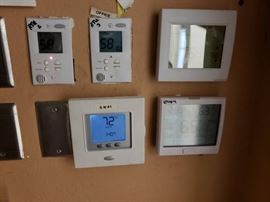 Digital thermostat controllers in office for AC un ...