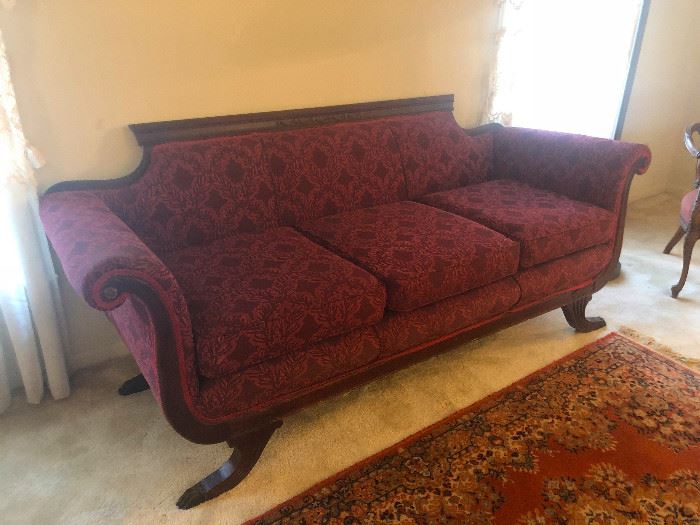 Antique Old Victorian Duncan Phyfe Sofa with four brass feet. Newly reupholstered 