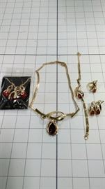 4 piece set: crossed gold and amber colored necklace, bracelet, earring, ring + packaged earring https://ctbids.com/#!/description/share/86425