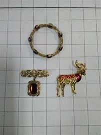 Elastic bracelet with red crystals, gold brooch with red stone, and deer brooch with assorted crystals      https://ctbids.com/#!/description/share/86474 