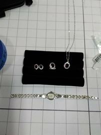 Silver necklace, ring, & pierced earrings with red stones and rhinestones silver watch with pearl face    https://ctbids.com/#!/description/share/86500