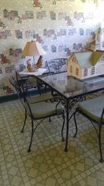 Glass top wrought iron table and chairs