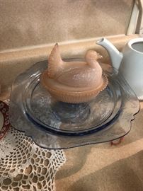 Pink hen on a nest dish