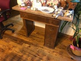 Old sewing machine cabinet with granite top