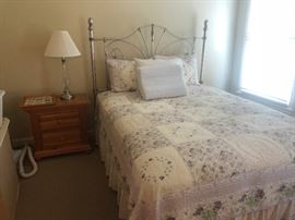 queen bed with iron headboard