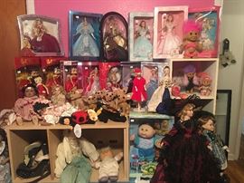 Large collection of dolls including Bratz, Betty Boop, troll dolls, and Barbies all in original boxes 