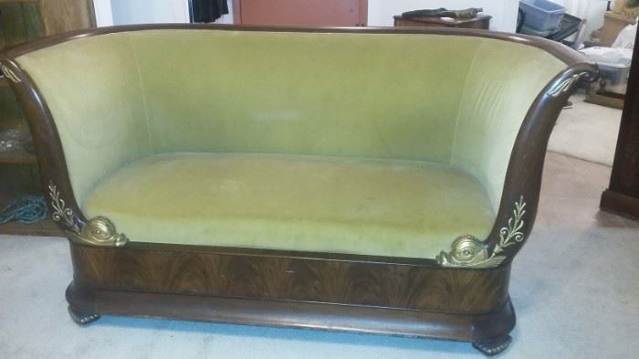 Early 1800's French Empire flame mahogany settee with gilt details.