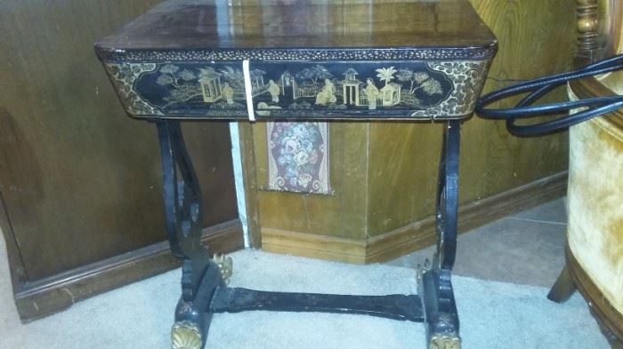 This is a circa 1850 to 1880 Chinese export black lacquer and gilt painted sewing cabinet with ivory accessories.