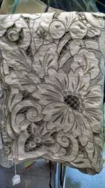Intricate cut out work tablecloth.