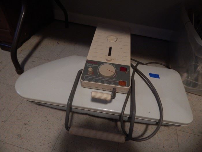 Electric table top ironing board press.