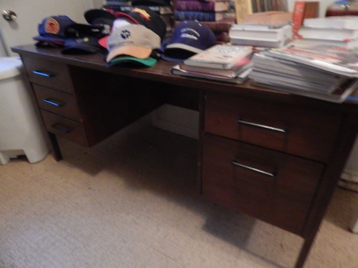 Home office desk. Baseball hat collection. Some hats are autographed. Several books too.